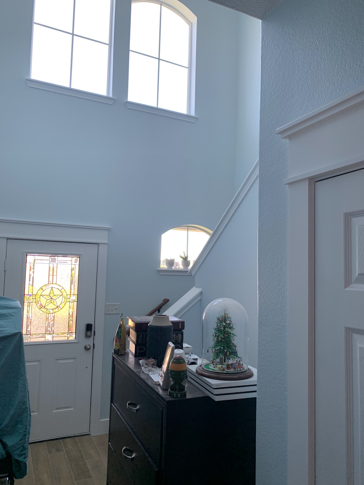 Interior painting: high-ceiling entryway, fresh light-blue walls