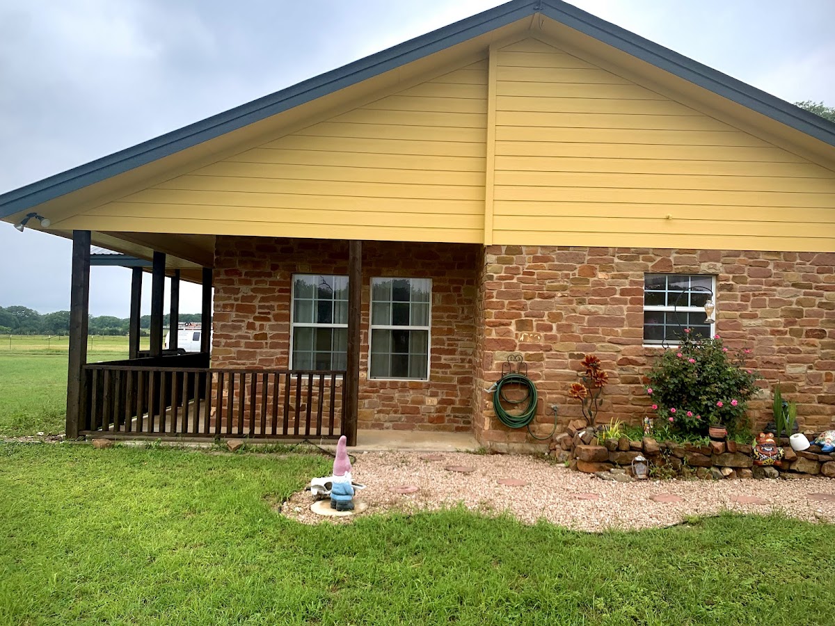 Exterior painting: country ranch home with yellow siding and brick
