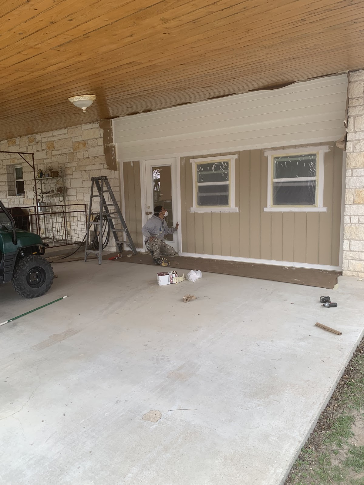 Exterior painting in progress: Hill Country stone home, beige siding